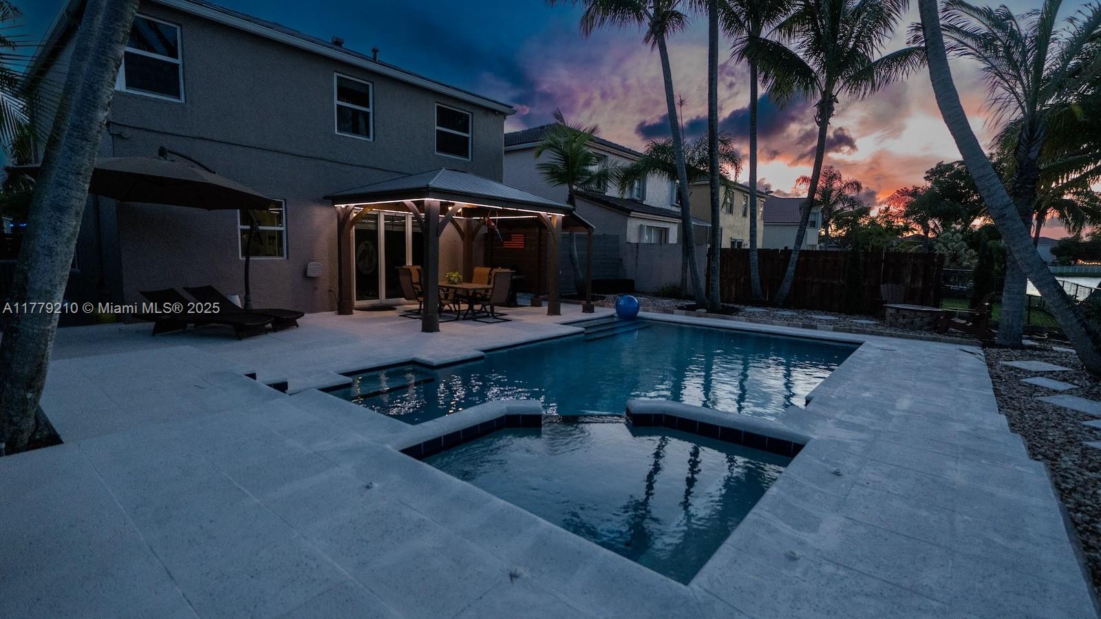 Towngate Pembroke Pines, FL 33028 - Photo 38 of 41 a view of a chairs and fire pit in the patio in front of retail shops