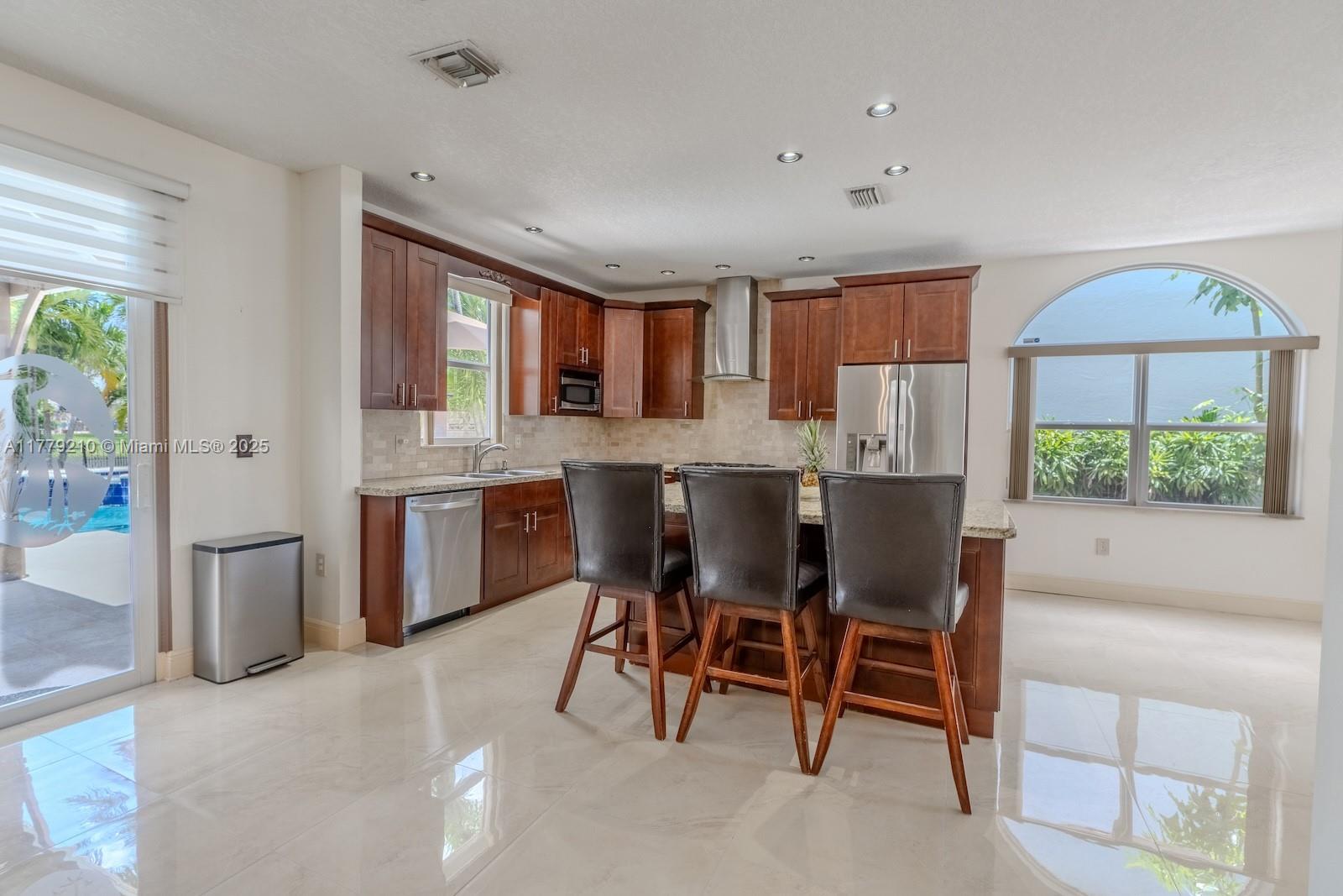 Towngate Pembroke Pines, FL 33028 - Photo 4 of 41 a kitchen with a table chairs sink and cabinets