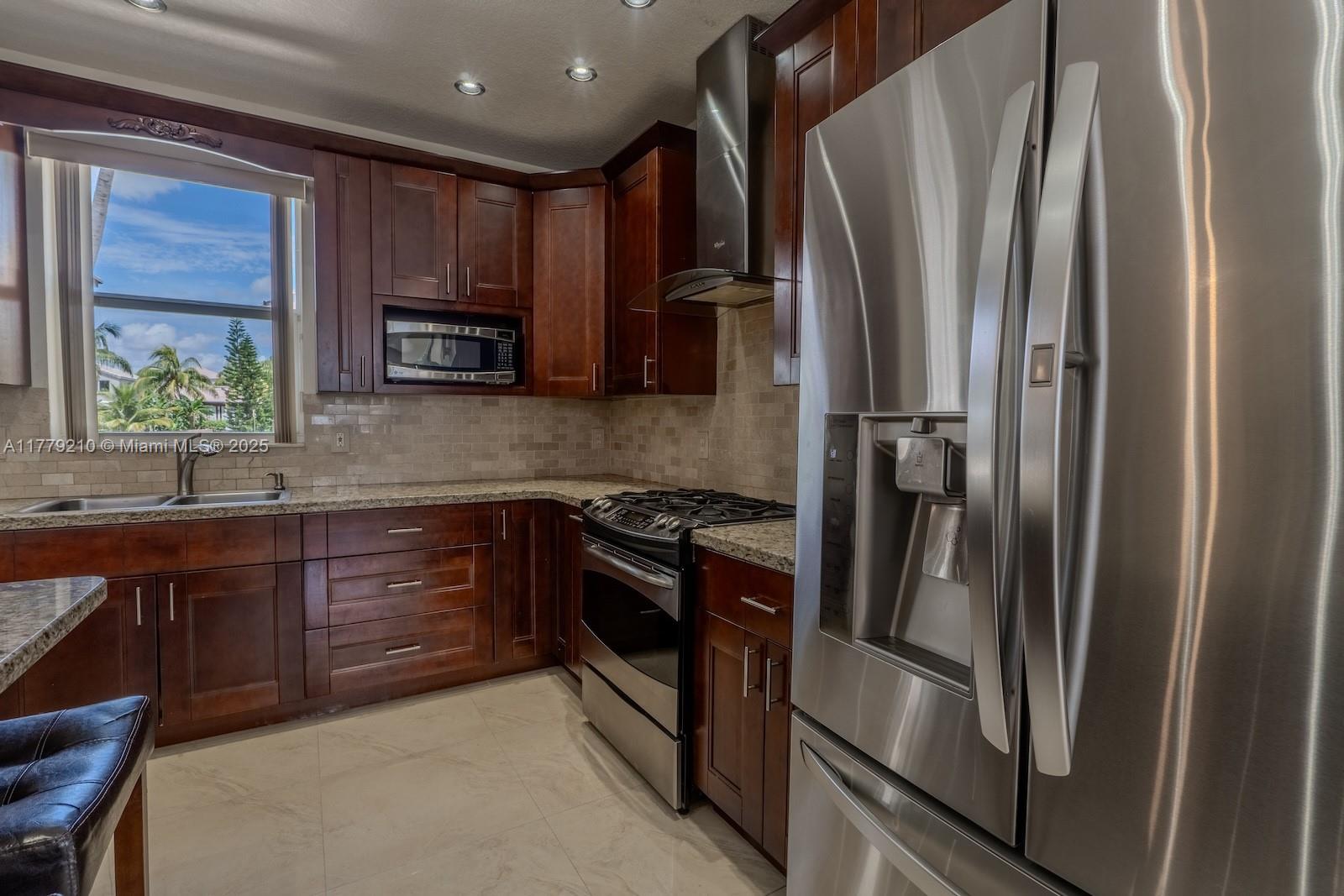 Towngate Pembroke Pines, FL 33028 - Photo 8 of 41 a kitchen with stainless steel appliances granite countertop a refrigerator and a sink