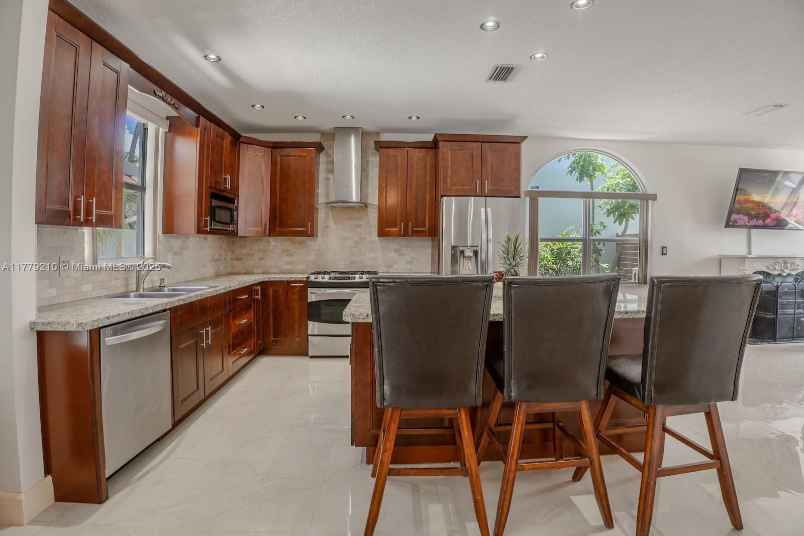 Towngate Pembroke Pines, FL 33028 - Photo 9 of 41 a kitchen with a table chairs sink and cabinets