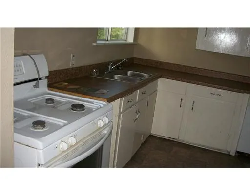 a kitchen with a stove a sink and a refrigerator