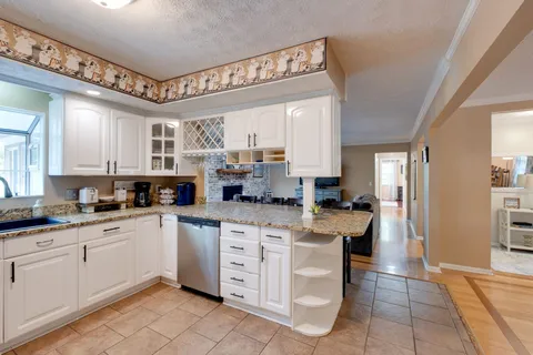 a large living room with furniture and a wooden floor