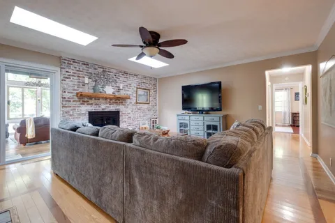 a bathroom with a tub sink a mirror a vanity and windows
