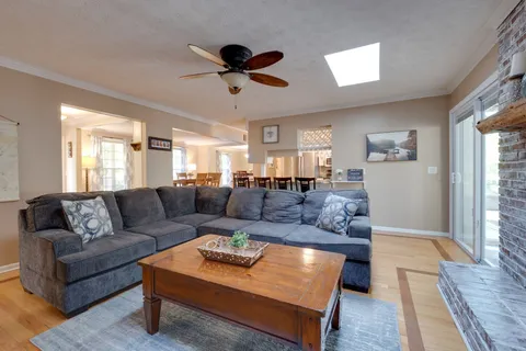 a bedroom with a bed and a lamp on dresser