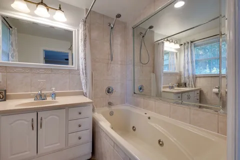 a bathroom with a sink a toilet and mirror