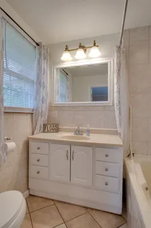 a bedroom with a bed dresser and a flat tv screen