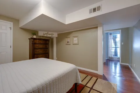 a roof deck with table and chairs potted plants with wooden floor