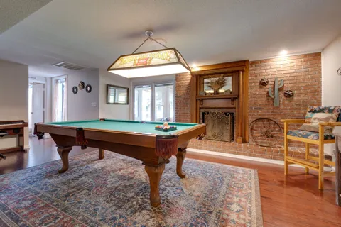 an aerial view of residential houses with outdoor space and trees