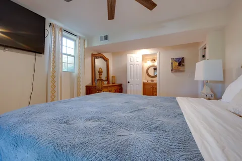 a bedroom with a large bed and a window