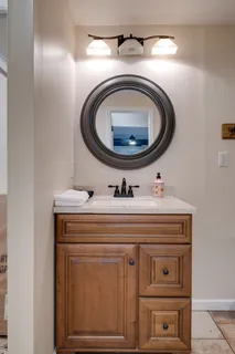 a view of empty room with window and wooden floor