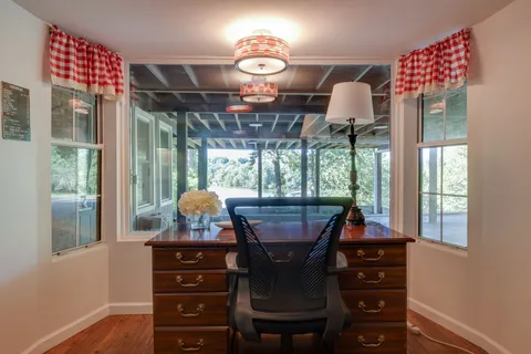 a view of a house with backyard and porch