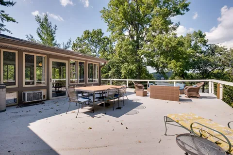 a living room with furniture and large windows