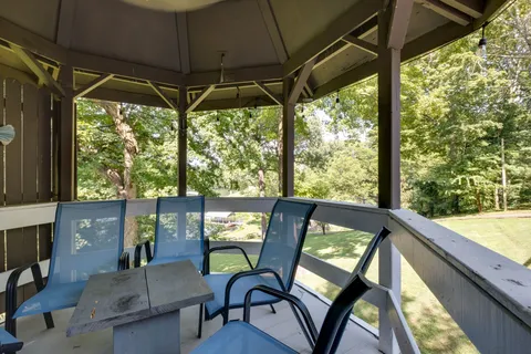 a view of a livingroom with wooden floor and a window