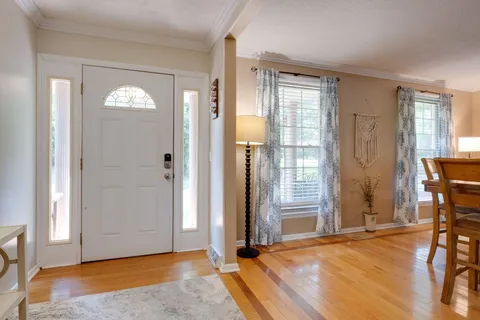 a large living room with stainless steel appliances kitchen island granite countertop furniture and a fireplace