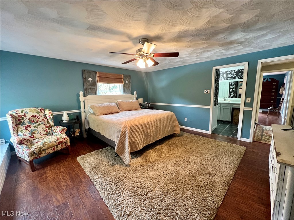 446 Annis Road Amherst, OH 44001 - Photo 24 of 39 Bedroom featuring ensuite bathroom, dark hardwood / wood-style floors, and ceiling fan