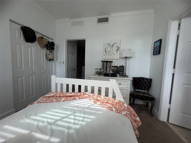 a bedroom with a bed and a chair in it