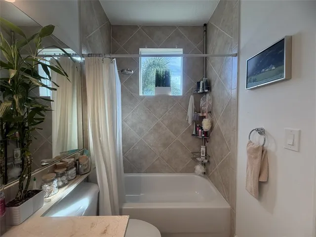 a bathroom with a tub and shower