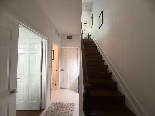 a view of a hallway with wooden floor and entryway