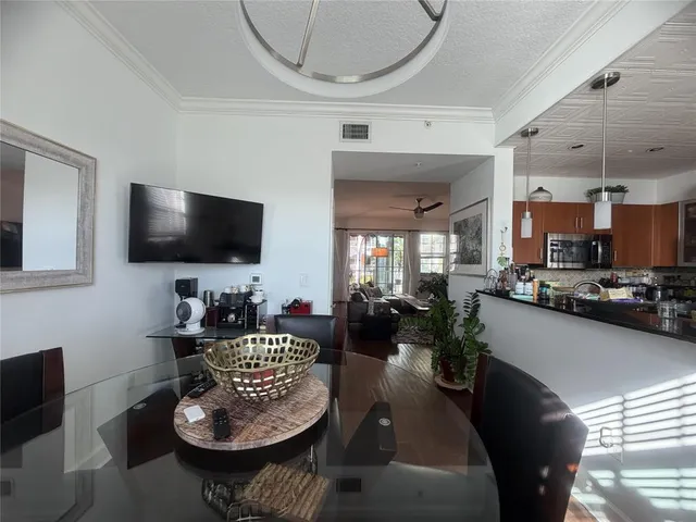 a living room with furniture a flat screen tv and kitchen view