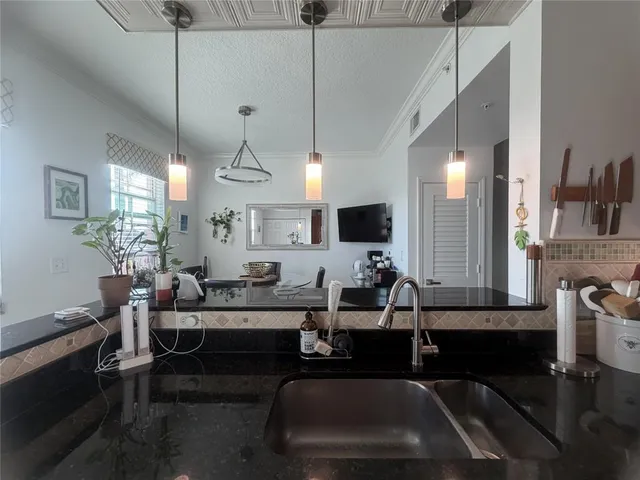 a room with lots of wooden furniture and a chandelier