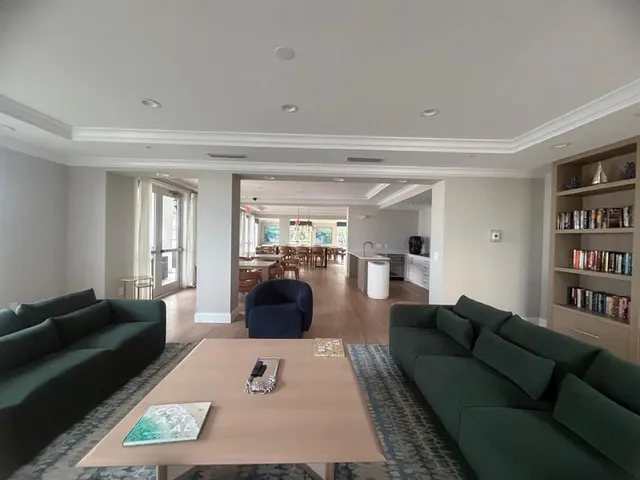a living room with furniture and a book shelf