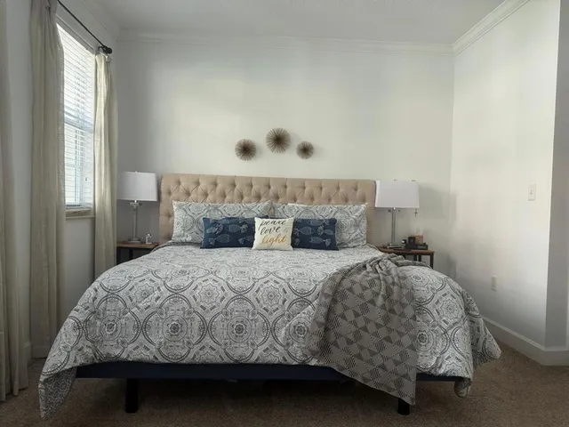 a bedroom with a bed and window