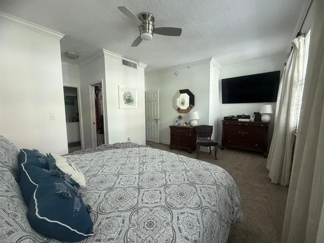 a bedroom with a bed and a television