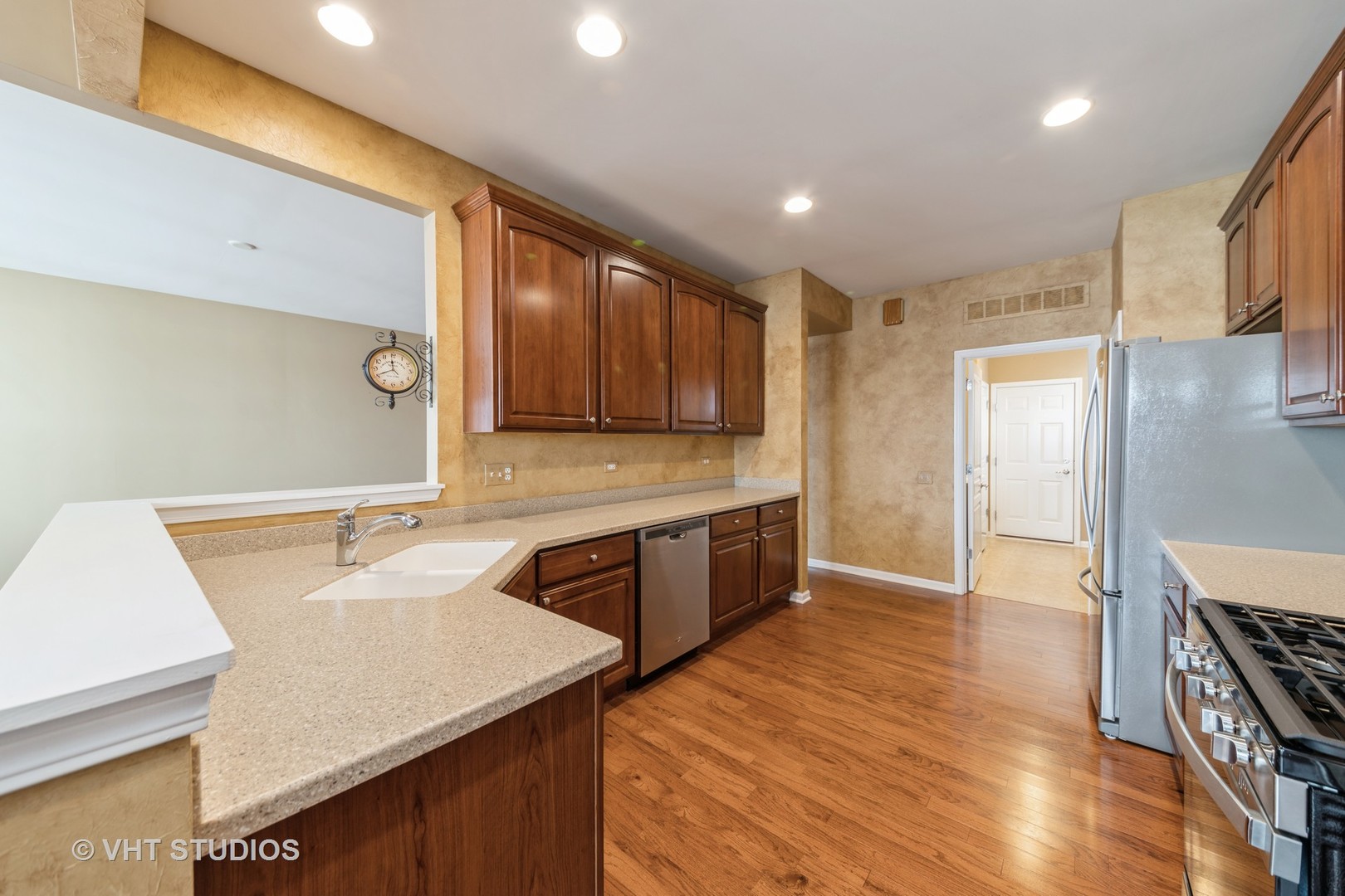 2795 Beacon Point Circle Elgin, IL 60124 - Photo 11 of 28 a kitchen with stainless steel appliances granite countertop a sink stove and refrigerator