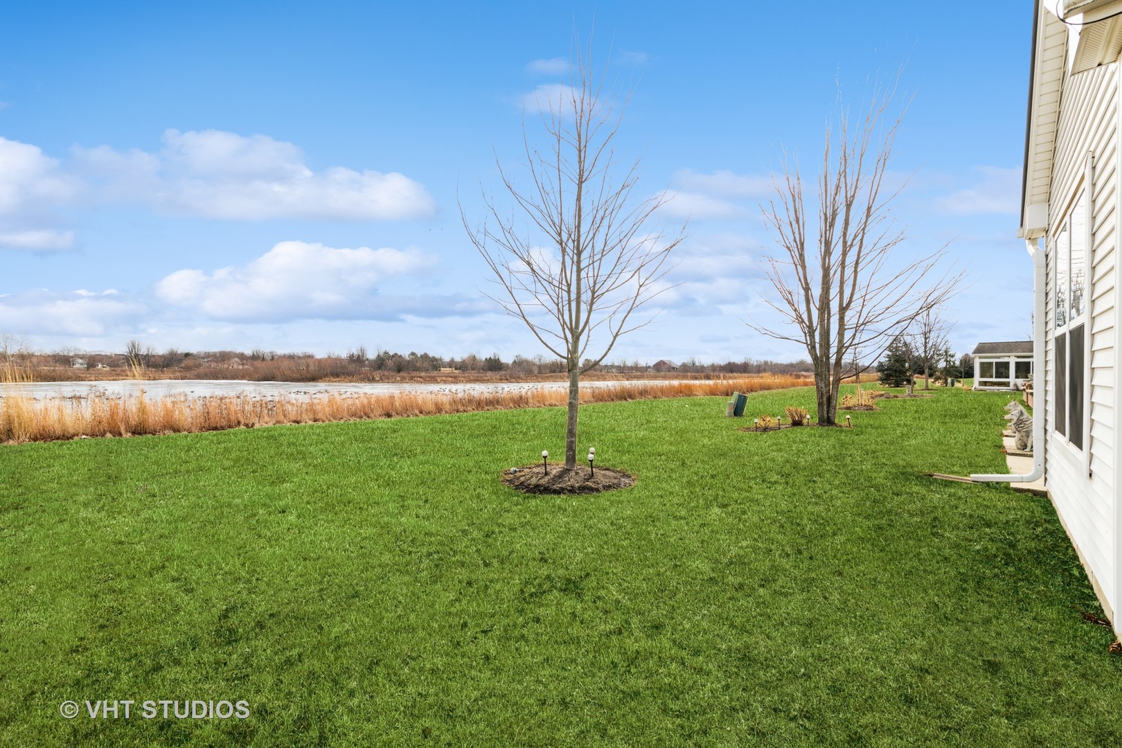2795 Beacon Point Circle Elgin, IL 60124 - Photo 24 of 28 a backyard of a house with lots of green space and lake view