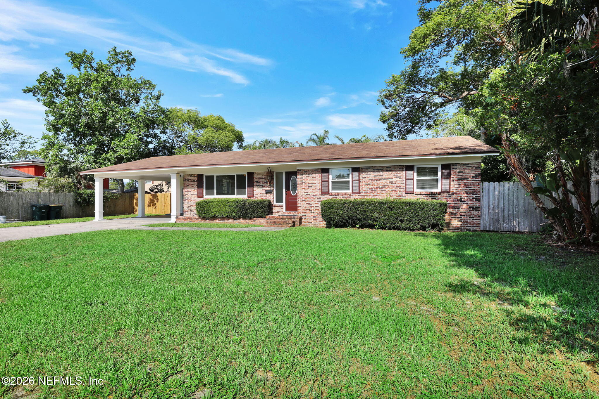a view of house with yard and outdoor seating
