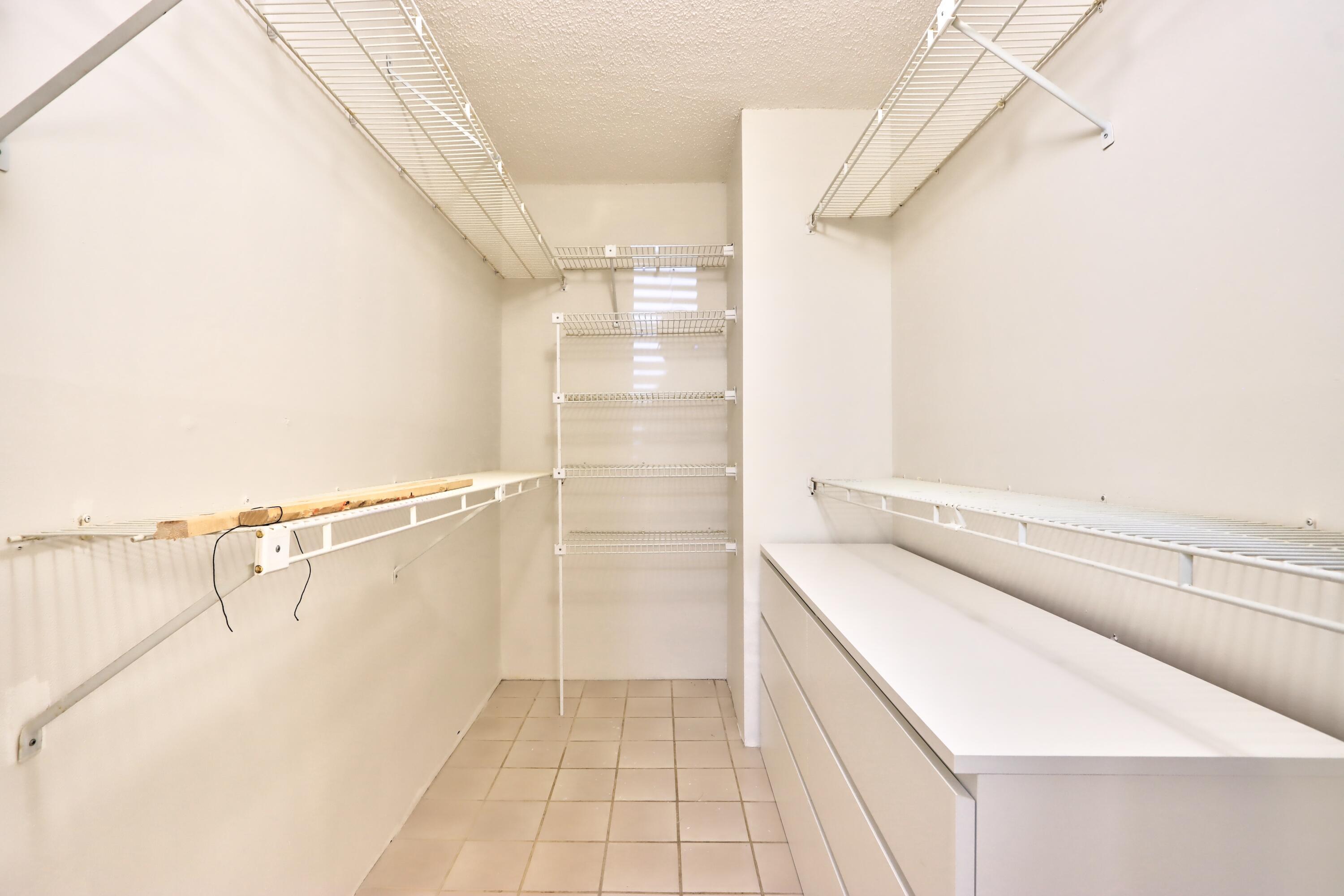 5800 Camino Del Sol, Unit 103 Boca Raton, FL 33433 - Photo 10 of 28 PRIMARY BEDROOM WALK-IN CLOSET