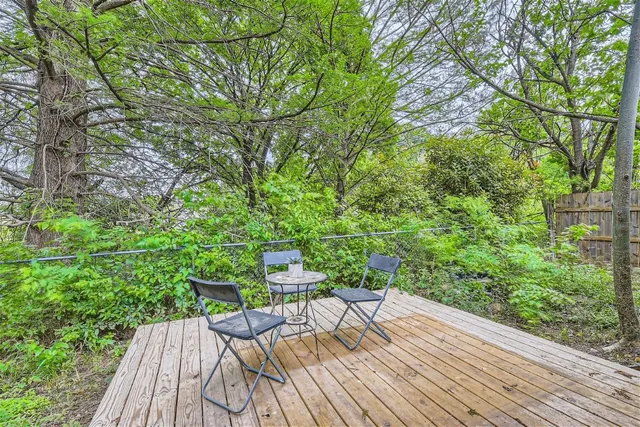 a view of balcony with wooden floor and outdoor seating