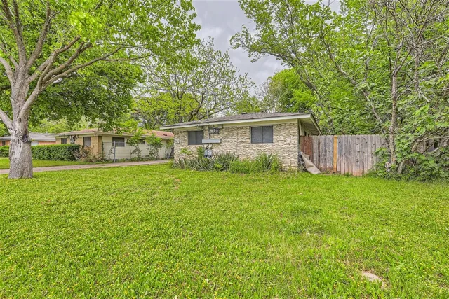 a view of house with backyard space and garden