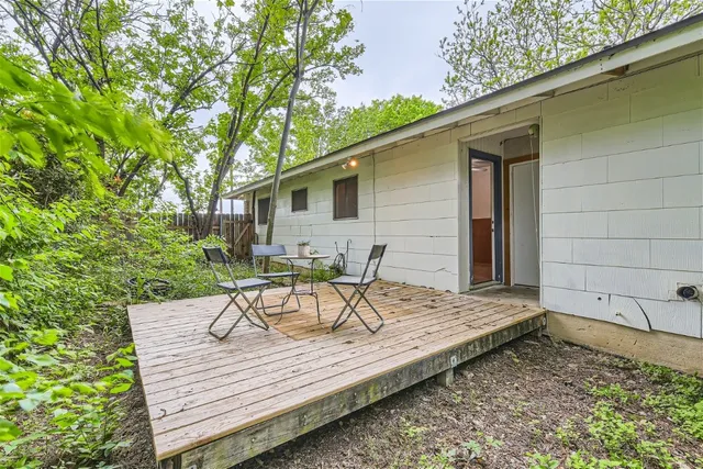 a view of a wooden chairs and table on the deck