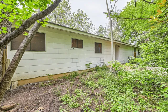 a side view of a house with a yard