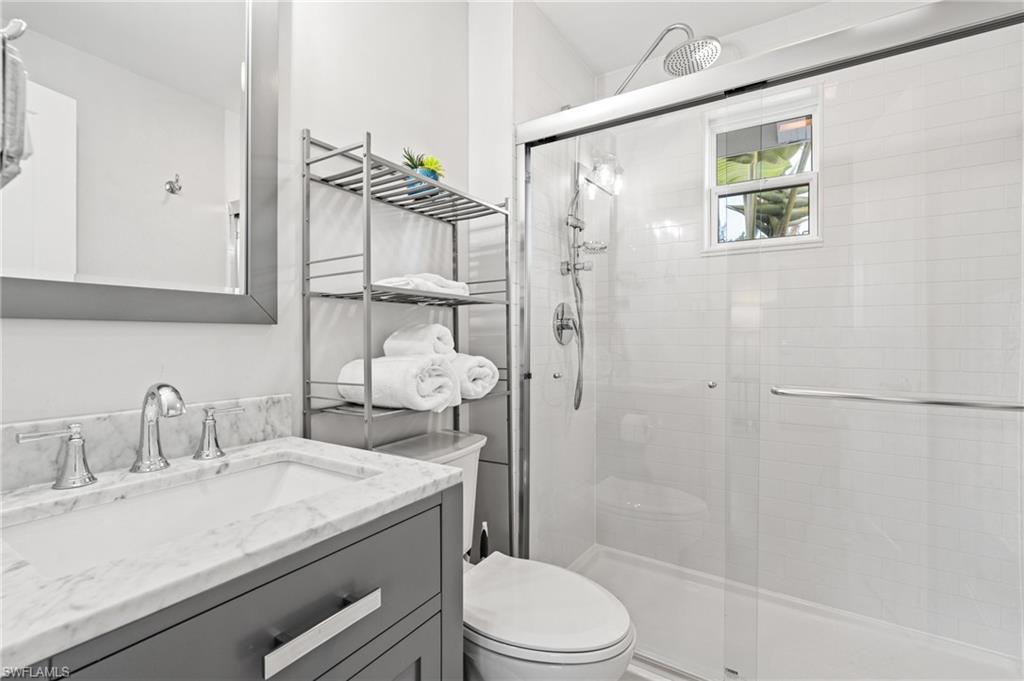 2134 Palm Street Naples, FL 34112 - Photo 15 of 36 Renovated bathroom: spacious shower with rainhead and sprayer