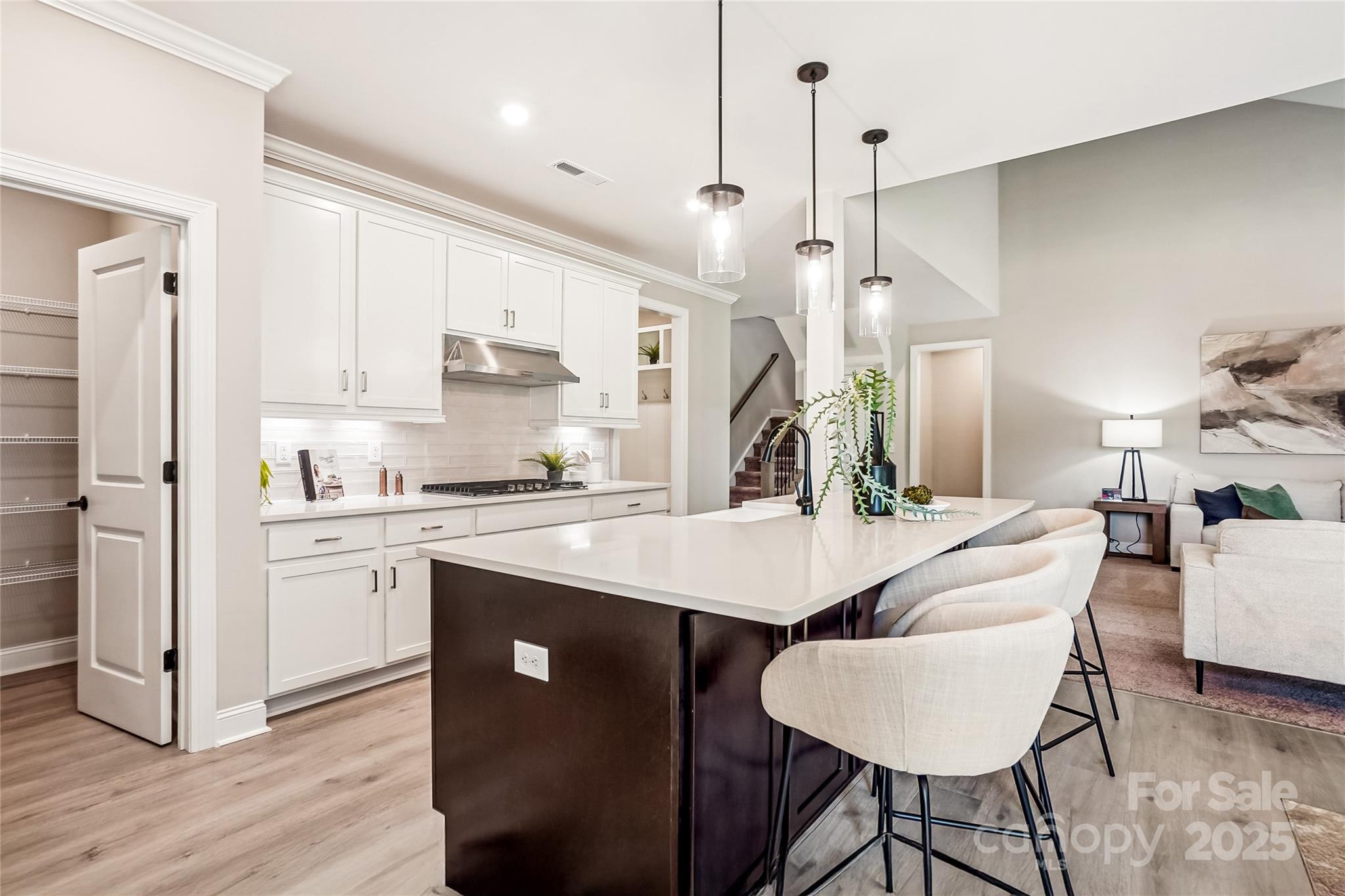 522 Fern Hill Road, Unit 17 Mooresville, NC 28117 - Photo 3 of 16 a open kitchen with stainless steel appliances granite countertop a refrigerator a sink dishwasher a stove and white cabinets with wooden floor