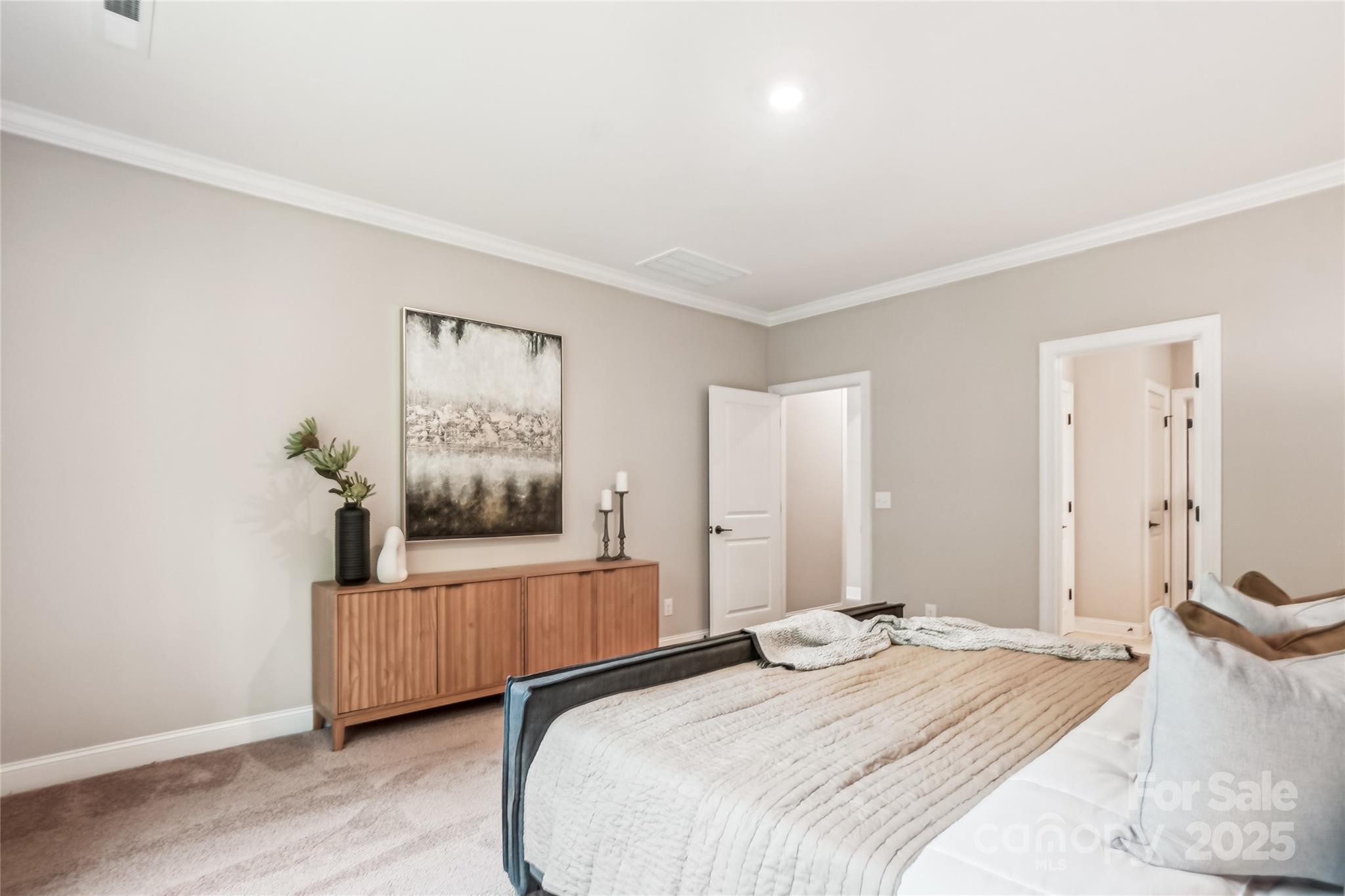 522 Fern Hill Road, Unit 17 Mooresville, NC 28117 - Photo 7 of 16 a bedroom with a bed and a painting on the wall