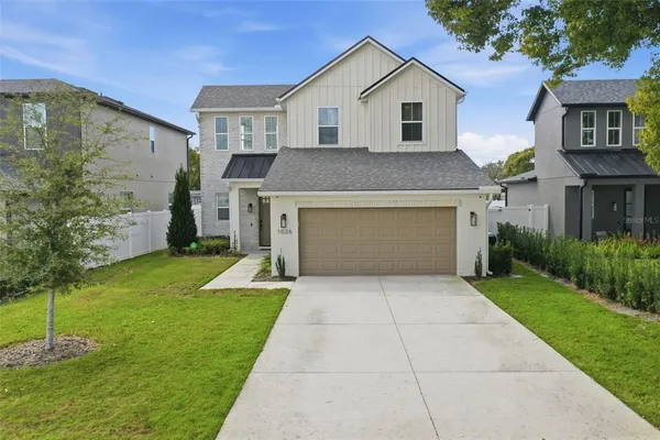 a front view of house with yard and trees