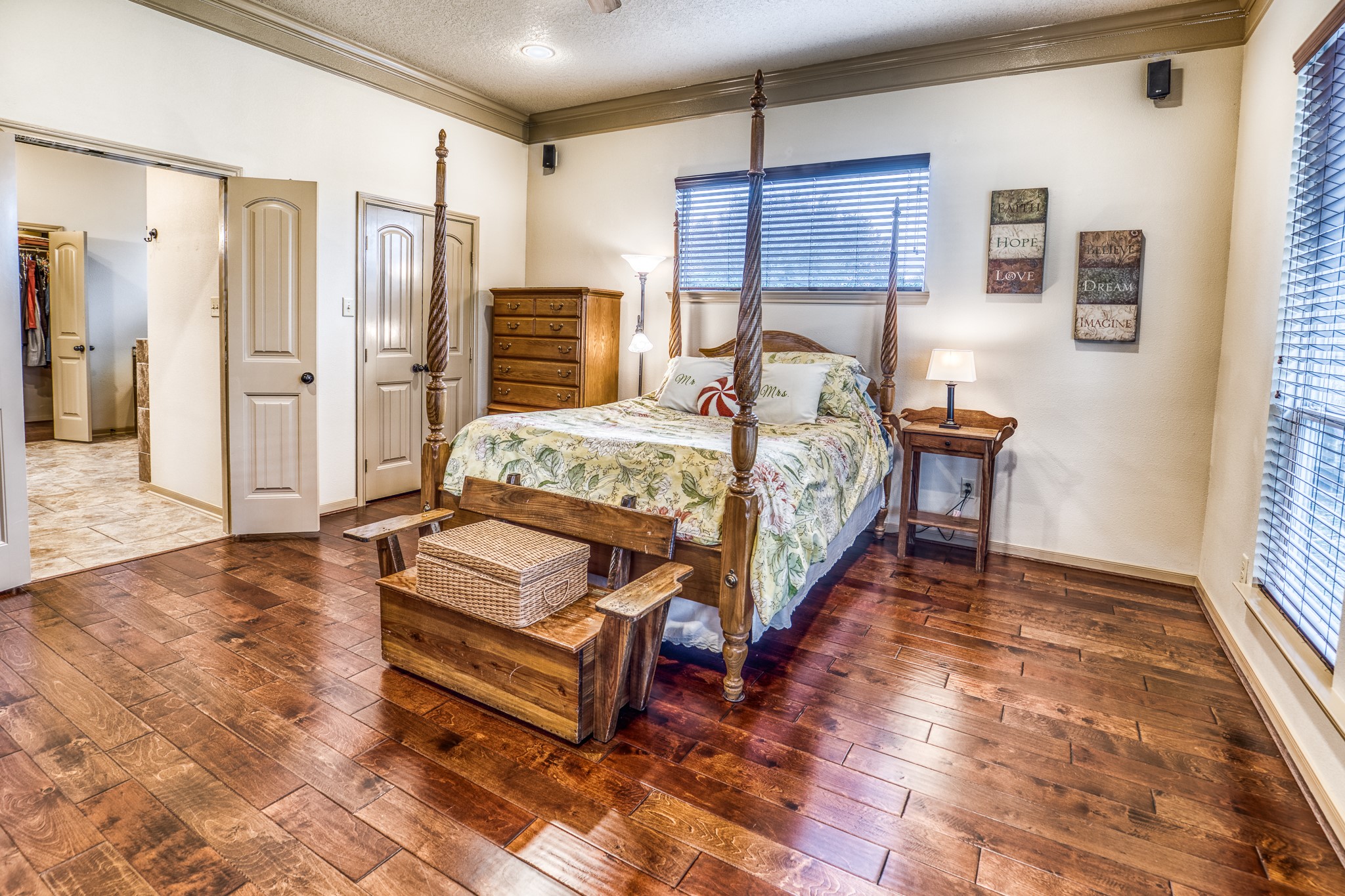 677 Grubbs Road Sealy, TX 77474 - Photo 12 of 40 a spacious bedroom with a bed and wooden floor