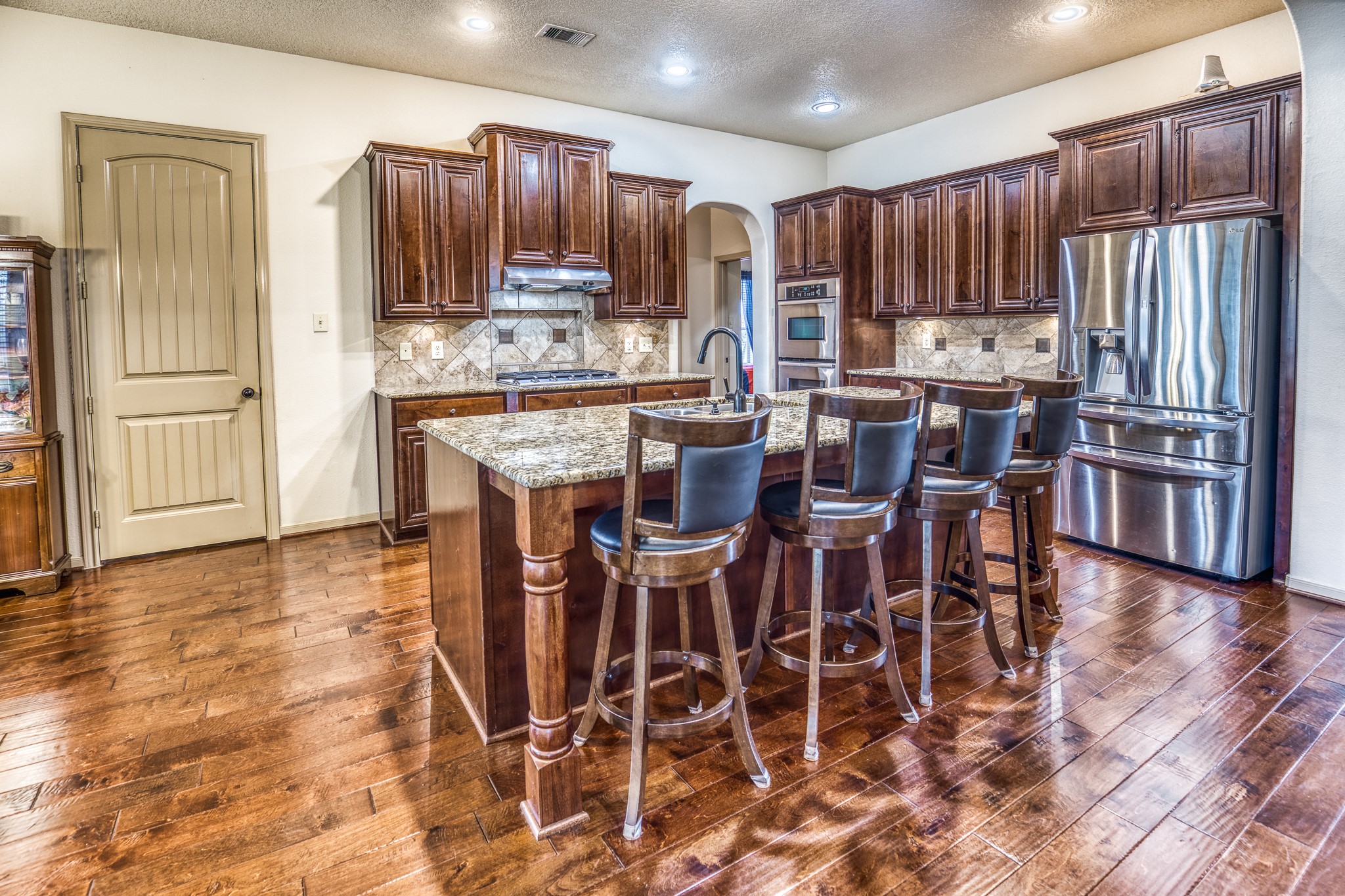 677 Grubbs Road Sealy, TX 77474 - Photo 9 of 40 a kitchen with stainless steel appliances kitchen island granite countertop a refrigerator and cabinets