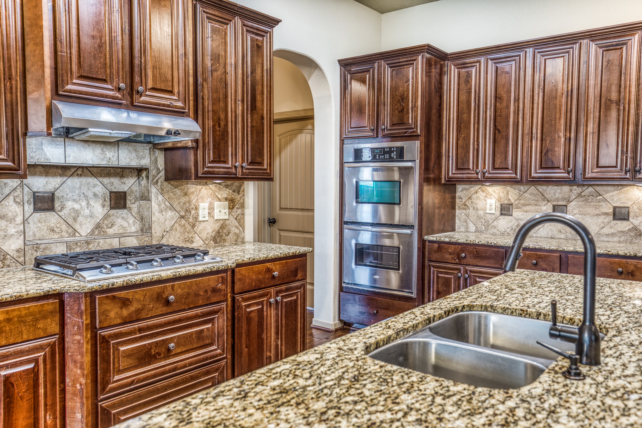 677 Grubbs Road Sealy, TX 77474 - Photo 10 of 40 a kitchen with stainless steel appliances granite countertop a sink a stove and cabinets