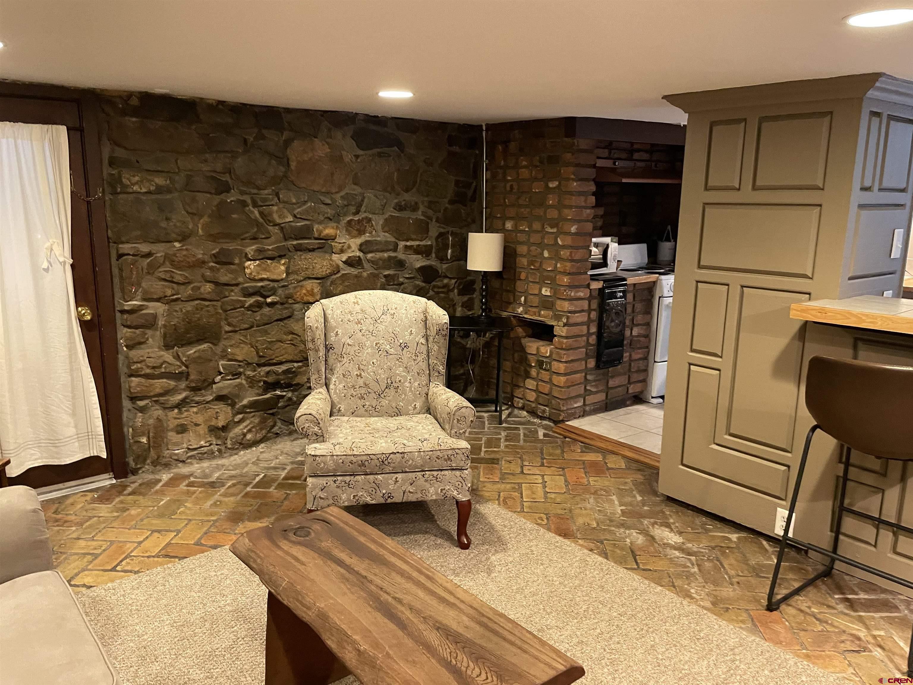 232 Main Street Ouray, CO 81427 - Photo 14 of 21 Living room in lower-level rustic, historic apartment