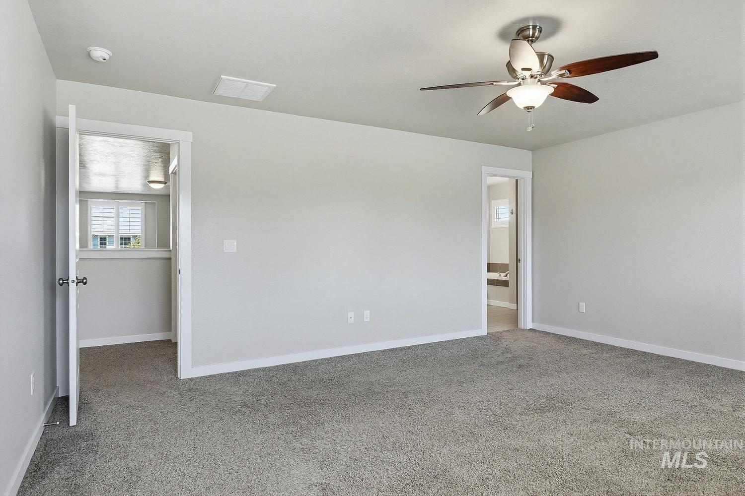 846 North Hidden View Way Star, ID 83669 - Photo 32 of 49 Spacious room featuring neutral carpeting, light gray walls, a contemporary ceiling fan with integrated lighting, and white trim throughout