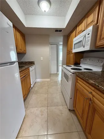 a kitchen with a stove top oven and cabinets