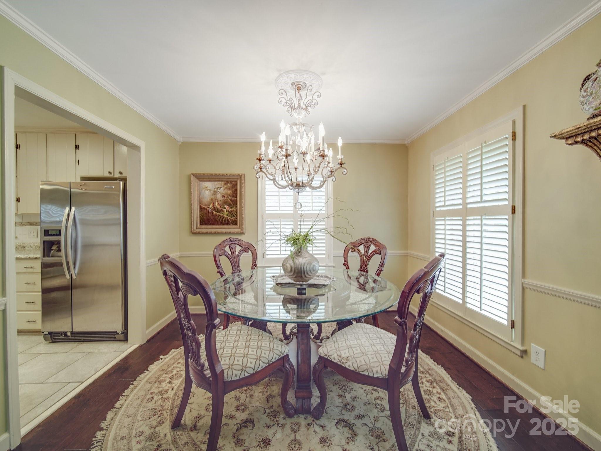 5411 Valley Forge Road Charlotte, NC 28210 - Photo 4 of 20 a dining room with furniture a chandelier and wooden floor