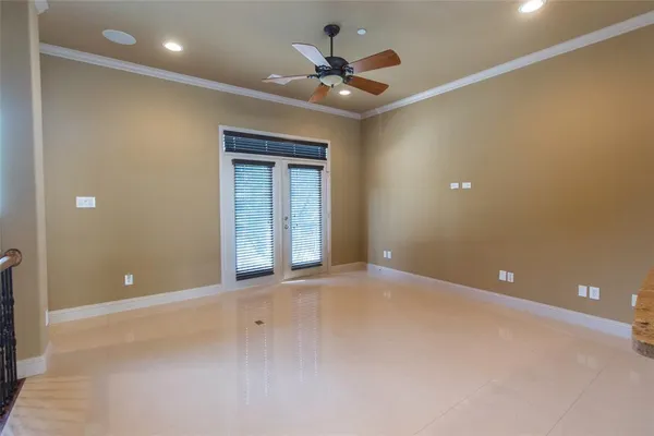 en empty room with a ceiling fan and a window