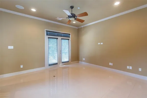 a view of an empty room with a ceiling fan