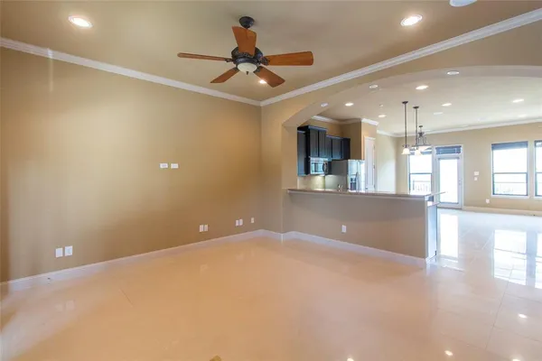 a view of a livingroom with a ceiling fan and window
