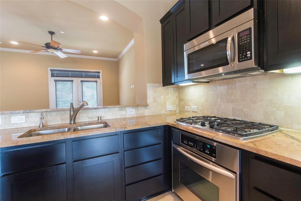 7416 Bishop Road Plano, TX 75024 - Photo 25 of 40 a kitchen with stainless steel appliances a stove sink and microwave